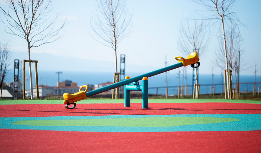 A playground seesaw, representing the push and pull between rising equity markets and ongoing geopolitical risk from Iran nuclear negotiations.